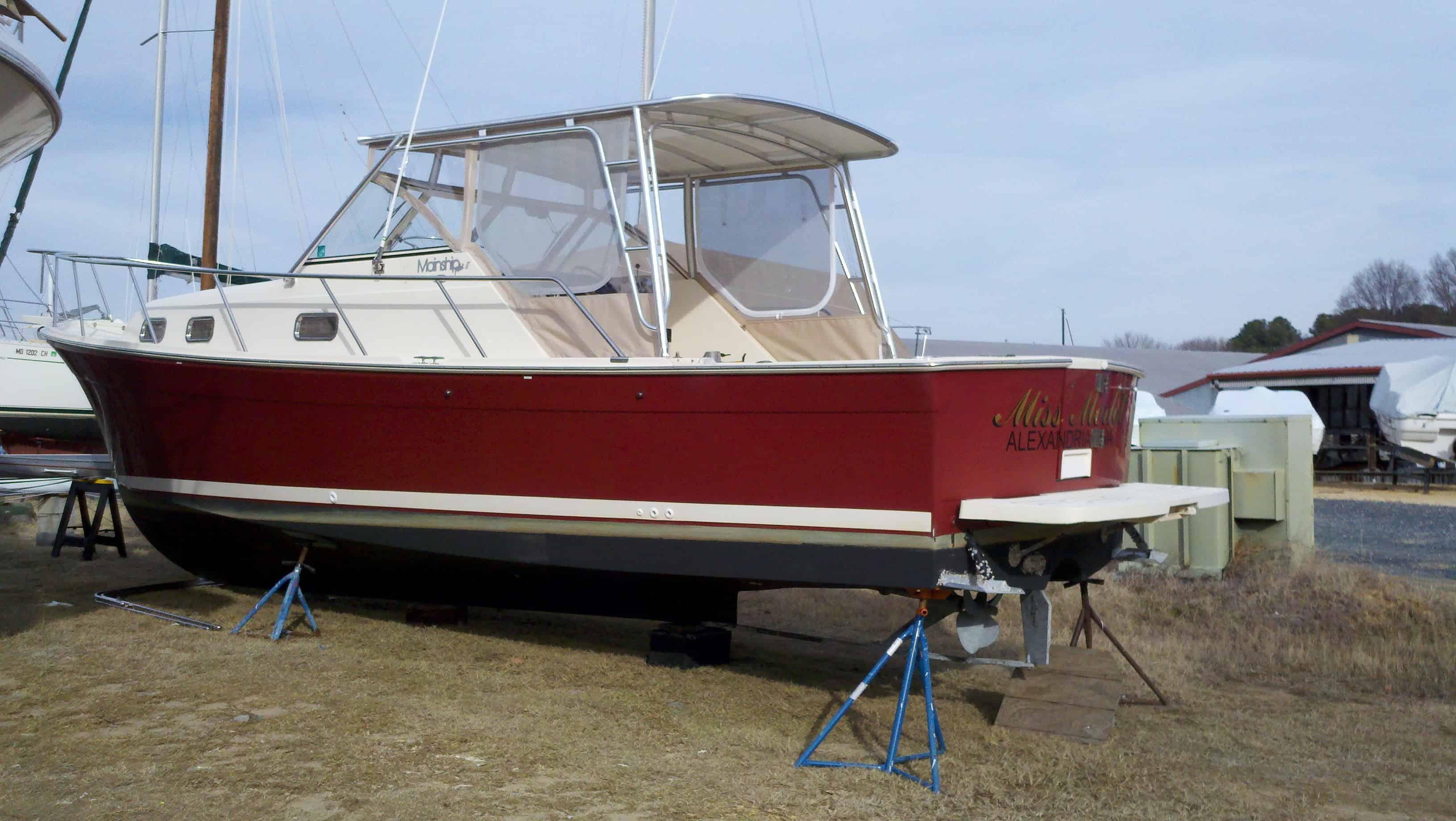 Atlantic Towers Top installed on a red boat dry-docked at a marina, with neighboring boats and equipment in the background.