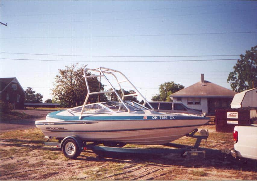 Atlantic Towers Air Tower installed on an Excel 190 boat parked on a trailer near a residential area.