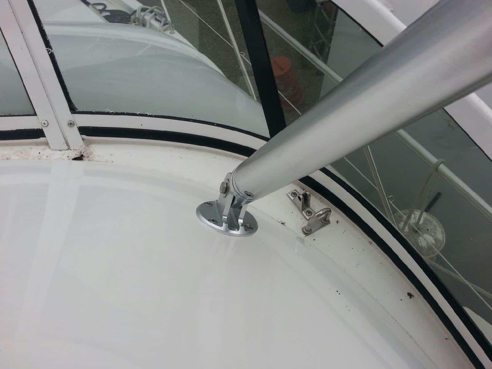 Atlantic Towers Top mounted on a Silverton boat, showcasing a polished metal pole and marine surroundings.