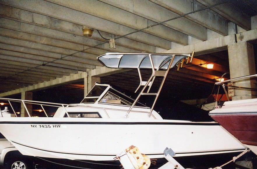 Atlantic Towers Top installed on a white Mako 223 boat stored under a concrete parking structure at night.