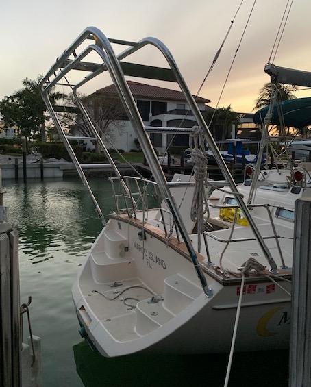 Atlantic Towers Arch installed on a boat docked in a marina, reflecting the surrounding scenery at sunset.