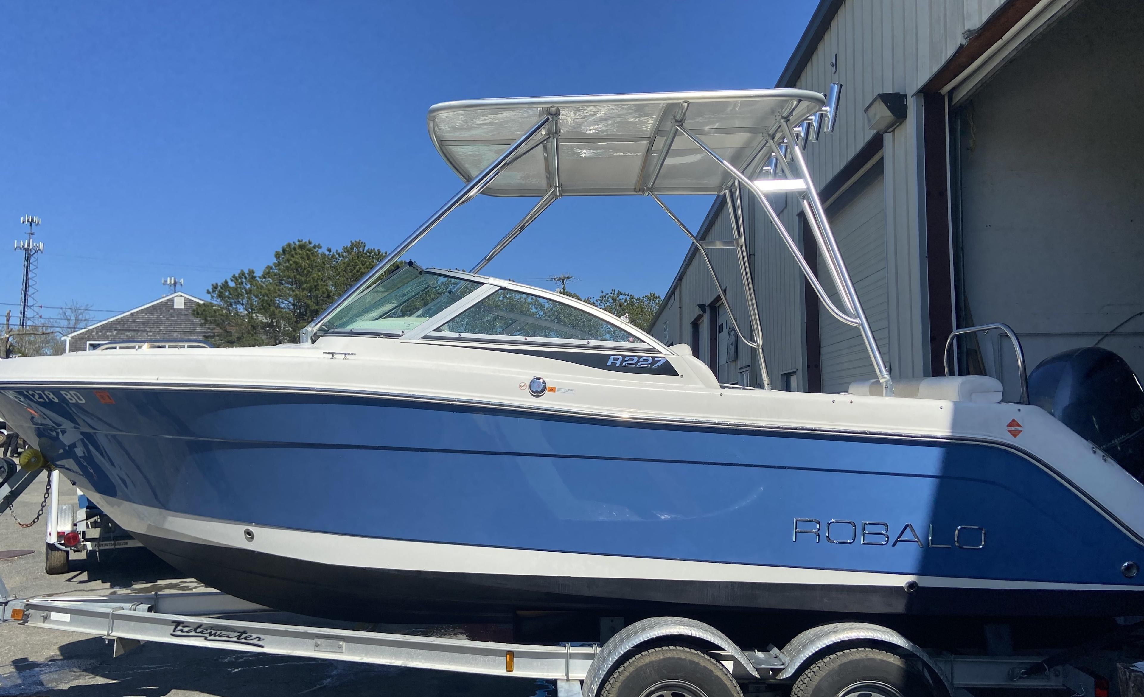 Atlantic Towers Top installed on a Robalo boat, showcasing a sleek blue hull and bright clear sky.