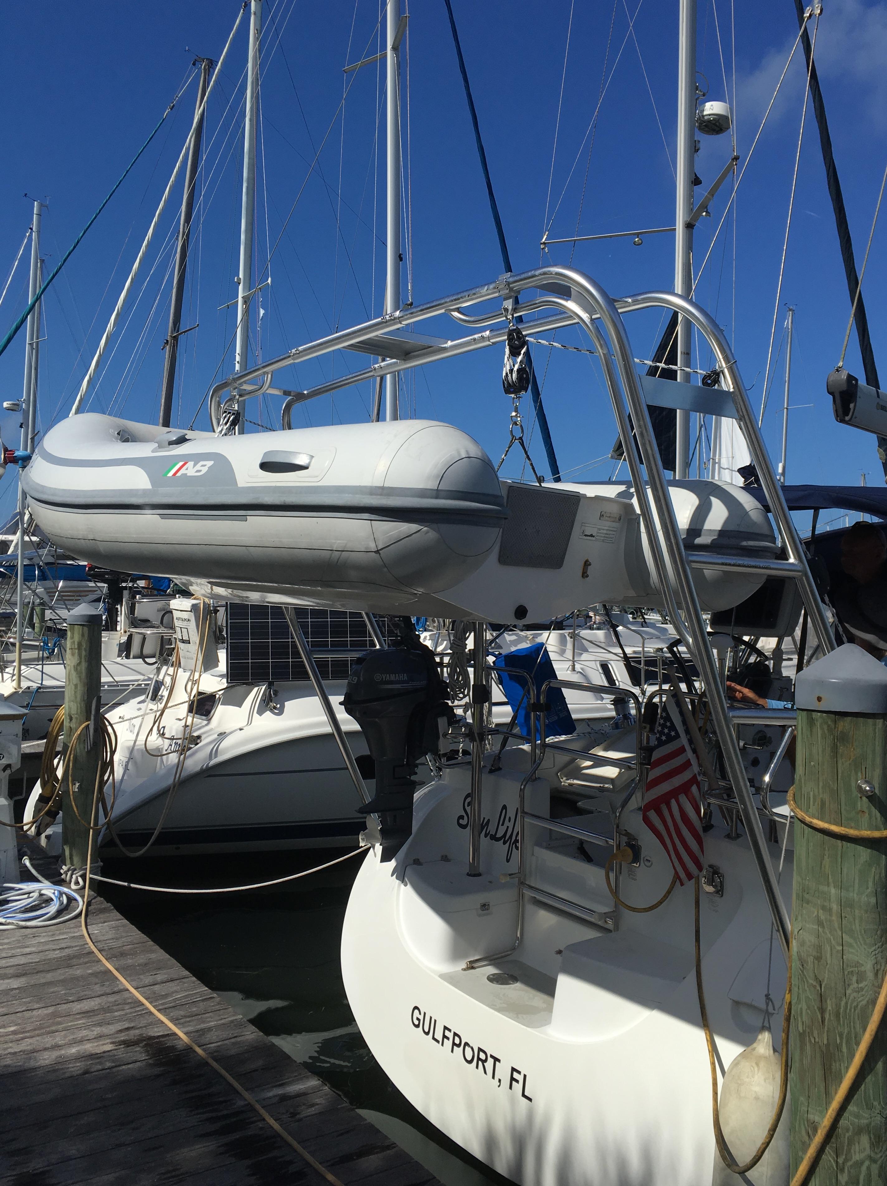 Atlantic Towers Arch installed on a boat with an inflatable dinghy in a marina setting.