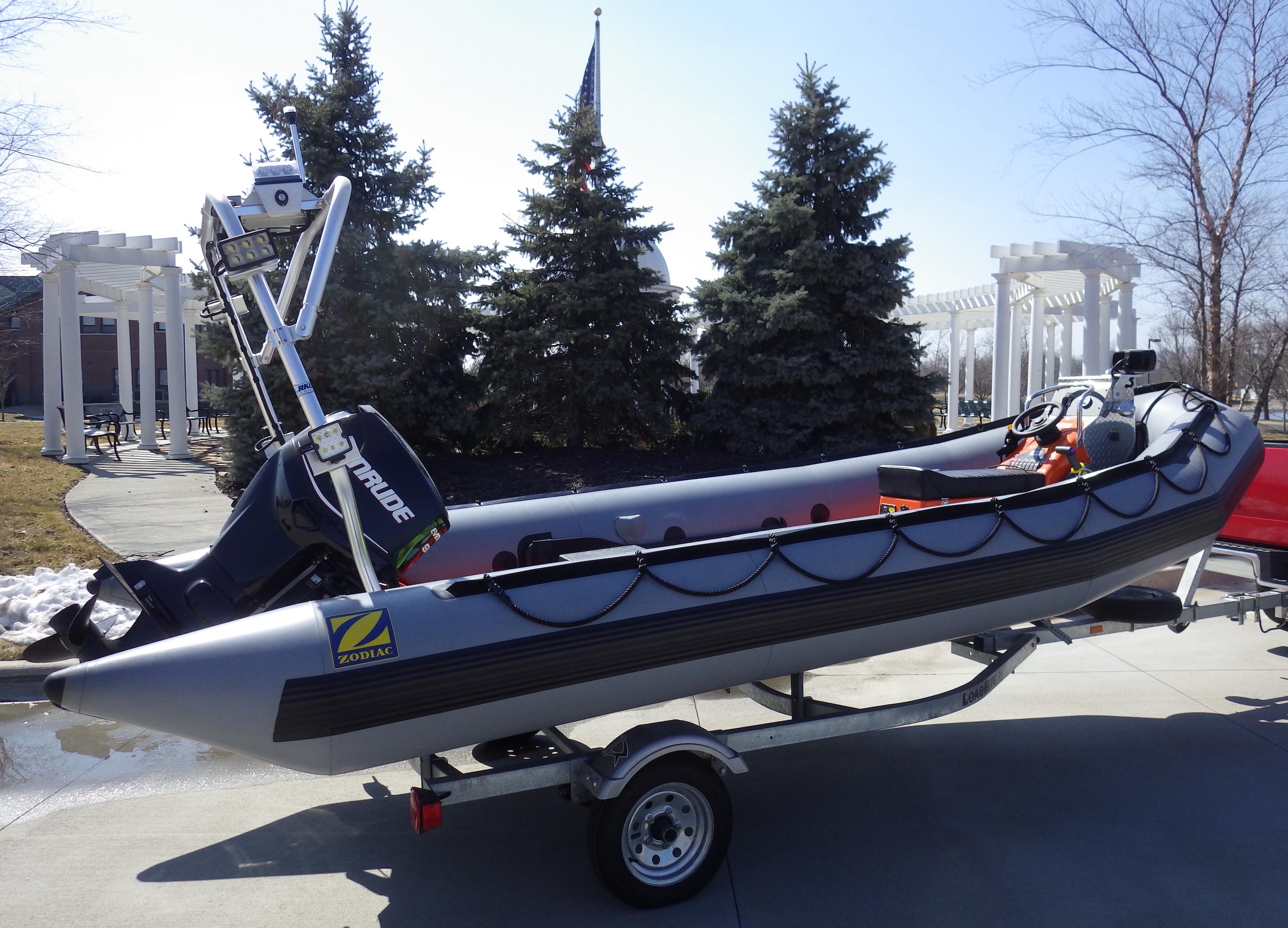 Atlantic Towers arch installed on a Zodiac boat, displayed on a trailer with trees in the background.