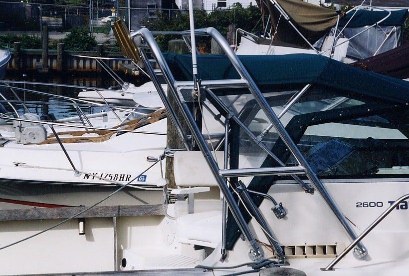 Close-up of a Tiara boat with an installed Atlantic Towers Arch made of polished metal tubing near the cockpit area.