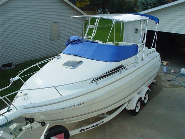 Atlantic Towers Top installed on an Excel boat, showcasing its white hull and blue covers, parked on a trailer.