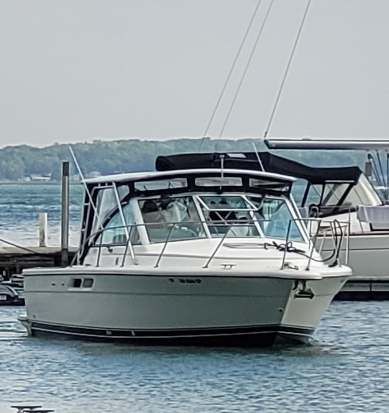 Atlantic Towers Top installed on a Tiara boat docked in calm waters, with surrounding boats and trees in the background.