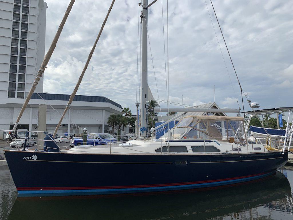 Moody sailboat docked at marina with Atlantic Towers Arch installed over cockpit covered by clear enclosure panels