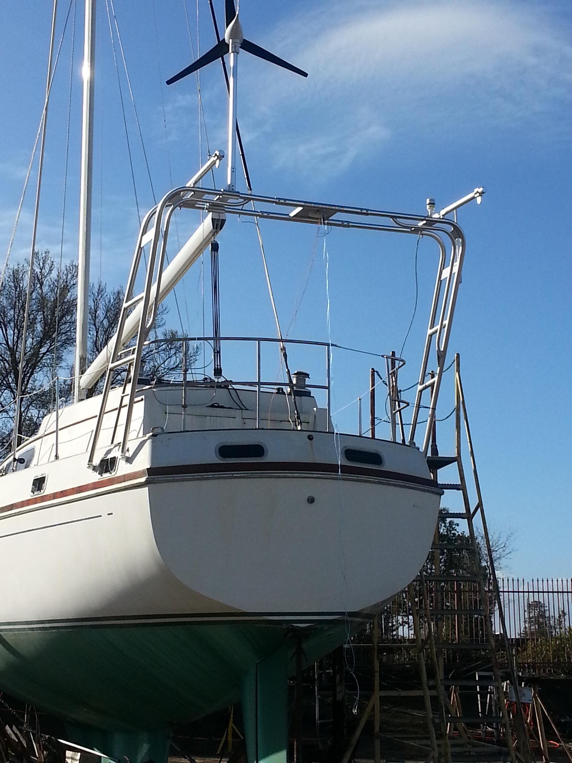 Stern view of a Gulfstar sailboat with an installed Atlantic Towers arch supporting rigging and equipment, dockside under clear sky.