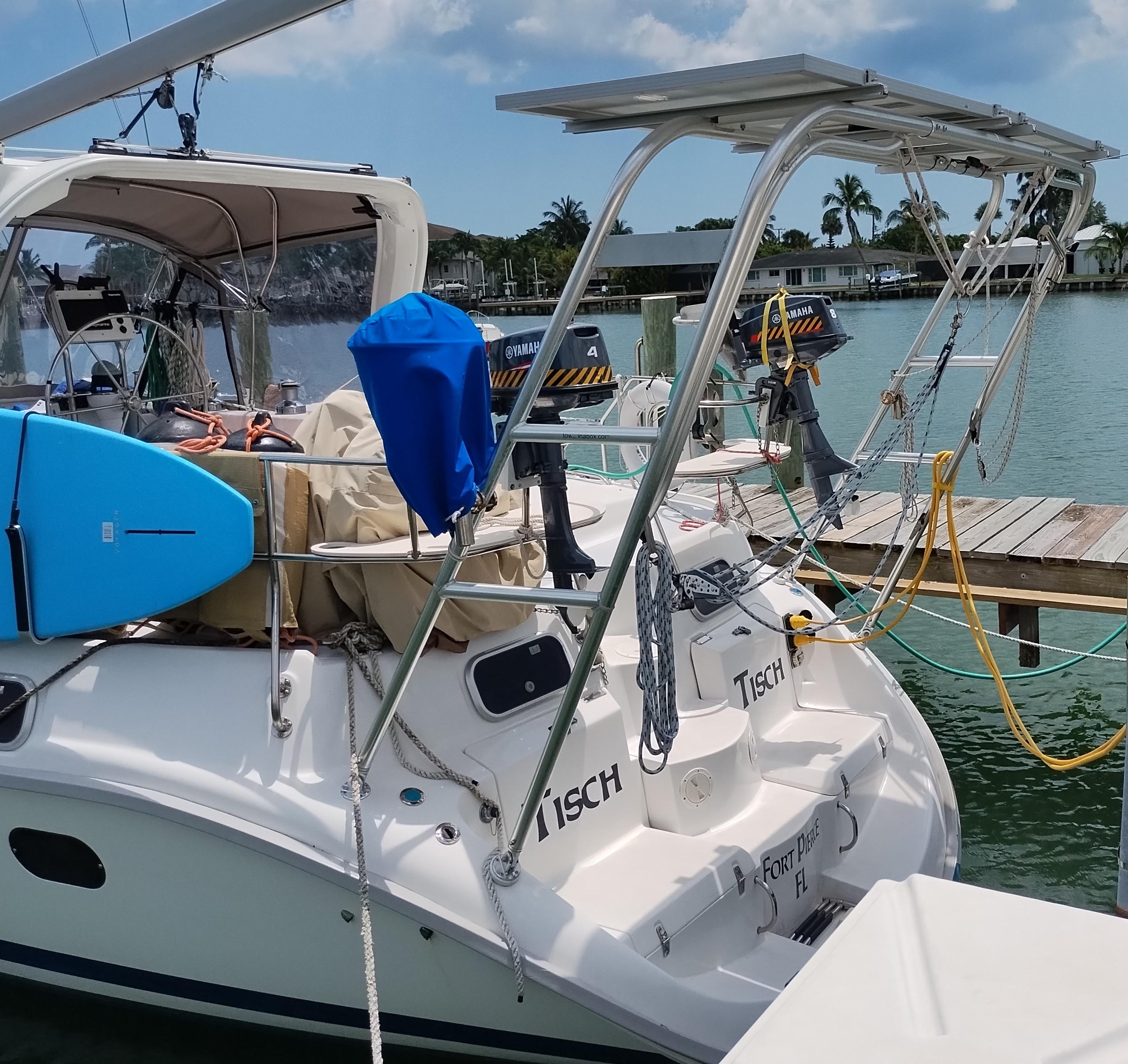 Atlantic Towers Arch mounted on a Hunter boat, featuring a blue paddleboard and docked near a waterfront.