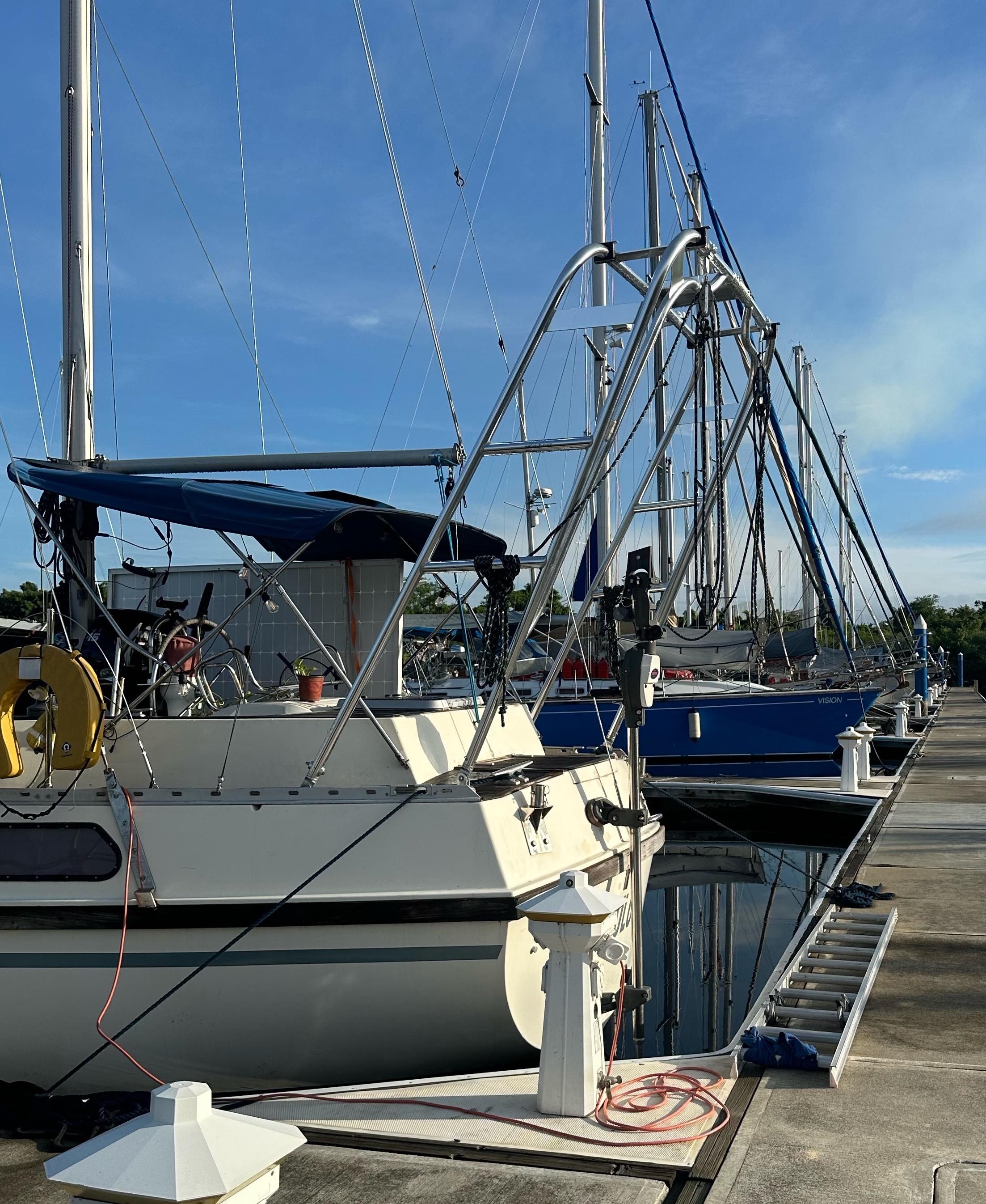 Atlantic Towers Arch installed on a boat in a marina, with surrounding boats and clear blue sky above.