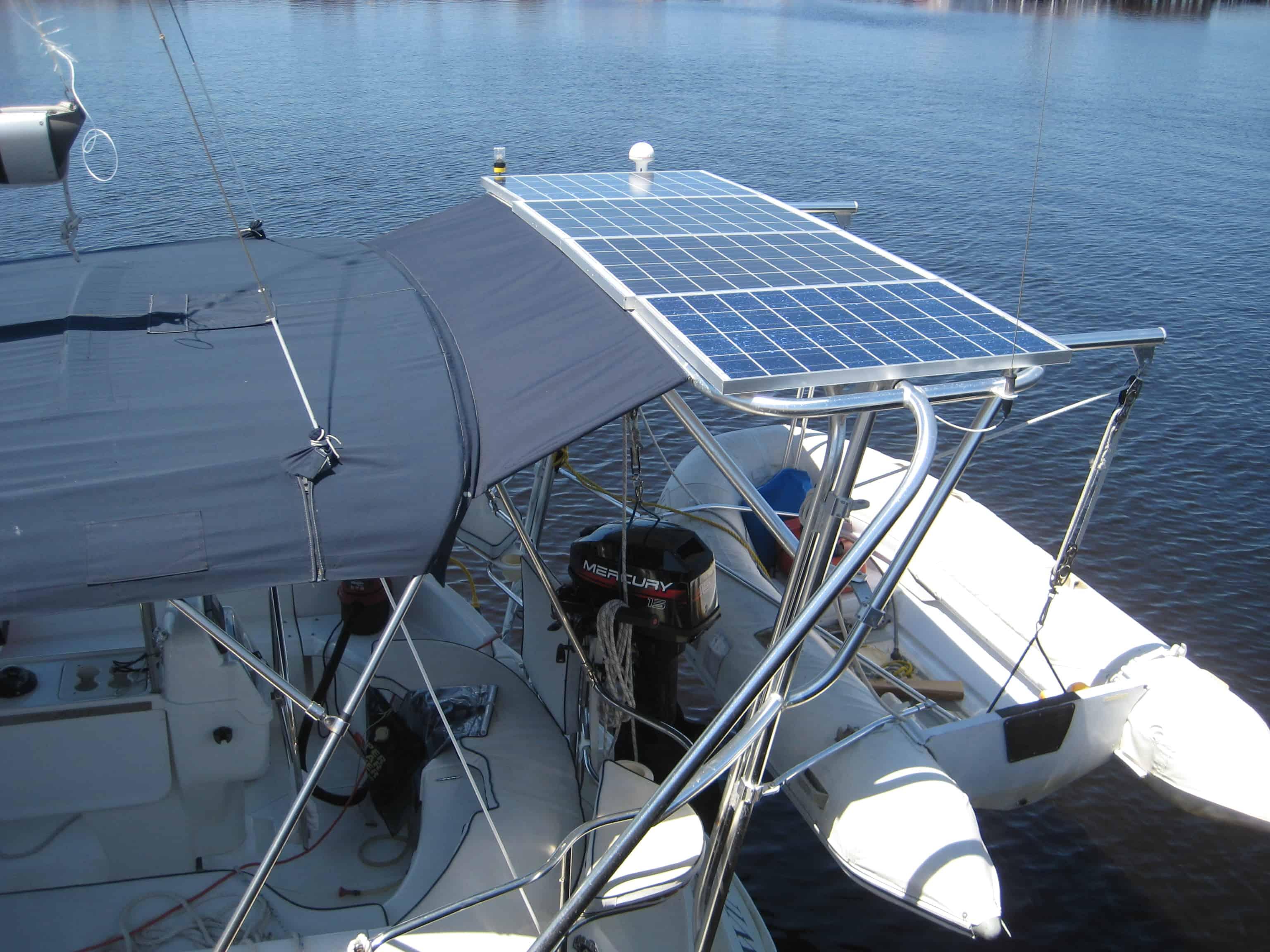 Atlantic Towers Arch installed on a Hunter boat, supporting solar panels above the cockpit area with water in the background.