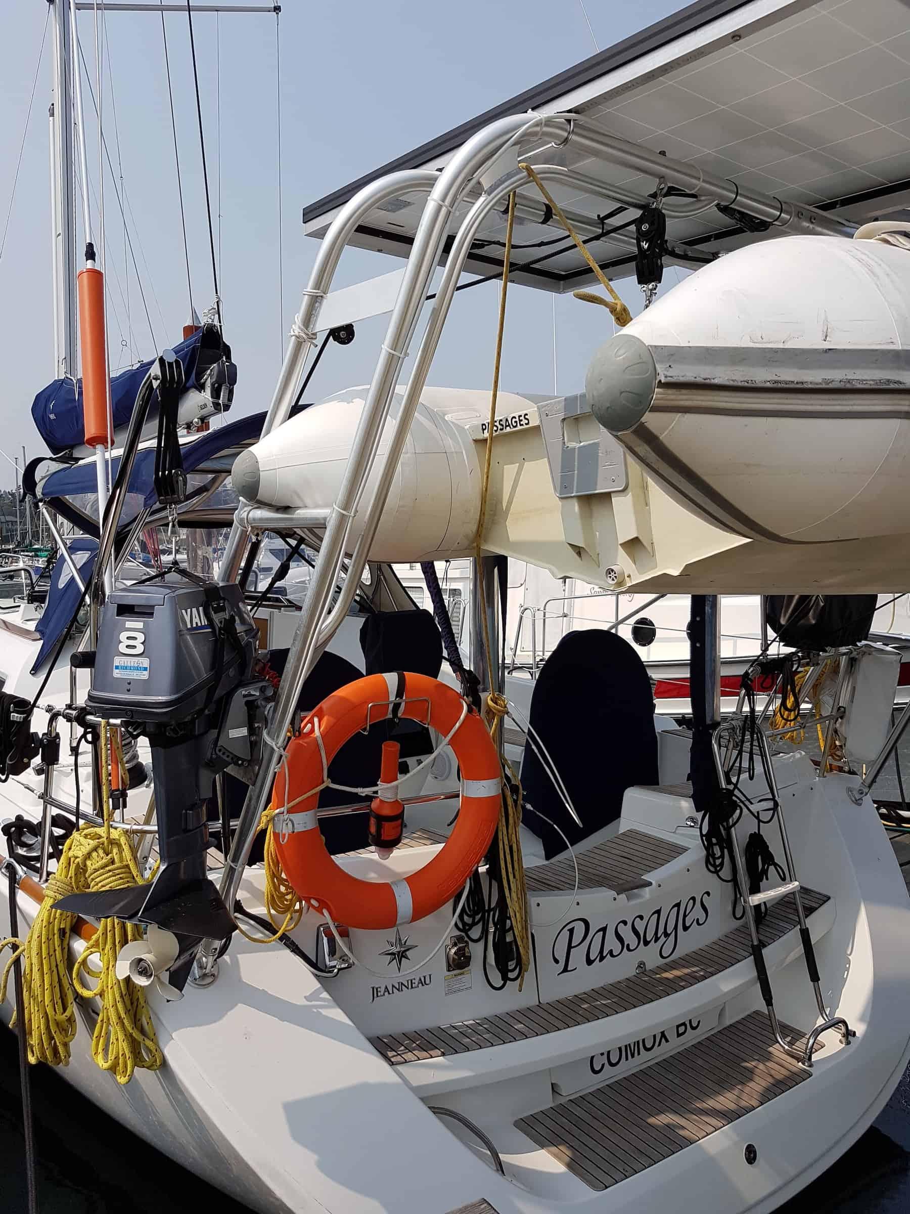 Atlantic Towers Arch installed on a Beneteau boat, featuring a life ring, ropes, and a Yamaha outboard motor.