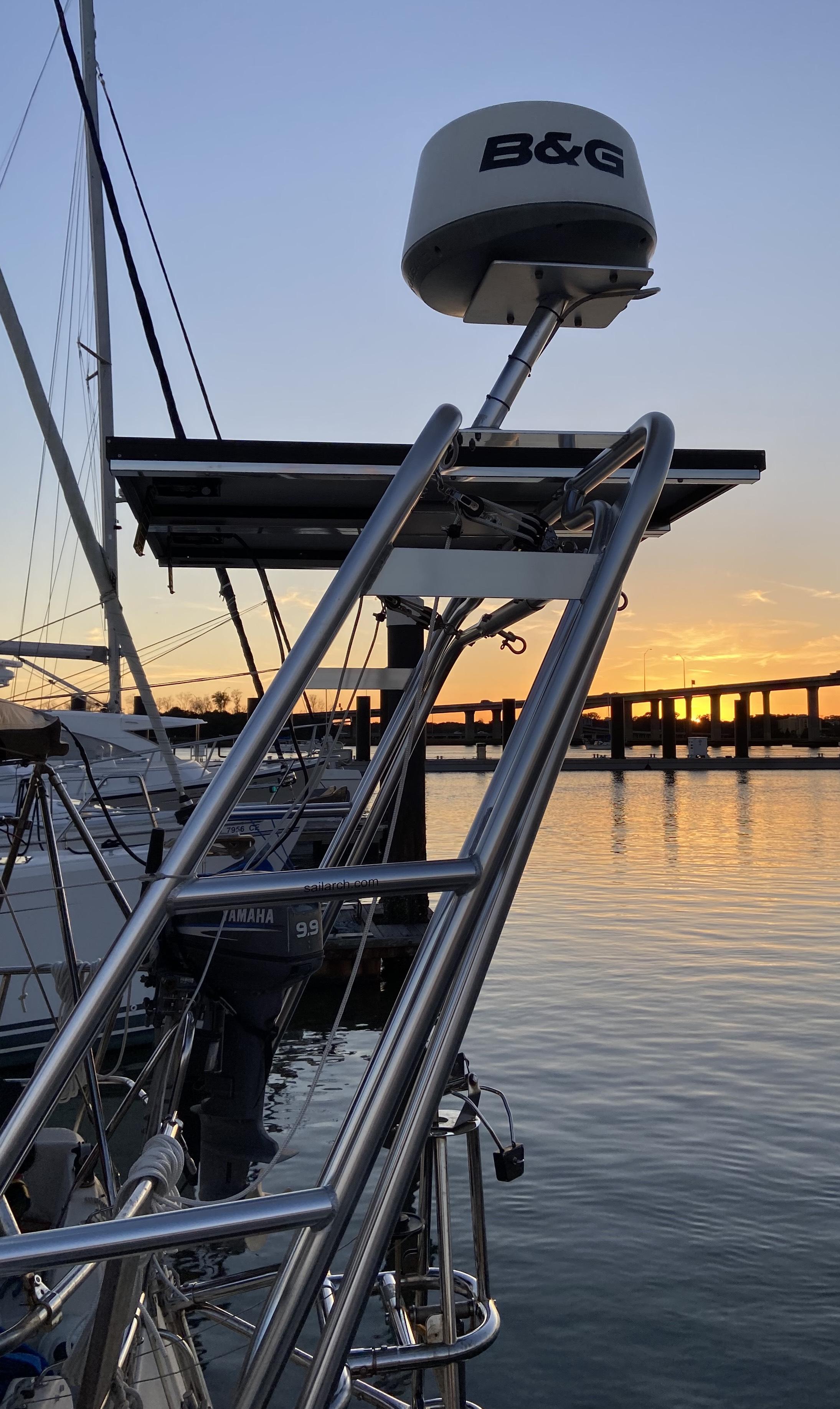 Atlantic Towers Arch mounted on a boat overlooking a sunset, with boats and docks in the background.