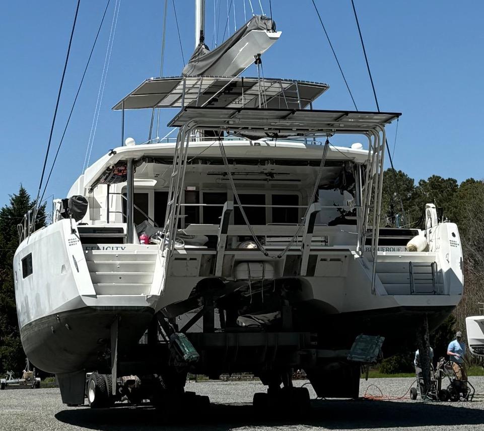 Rear view of a Lagoon boat on land equipped with an installed Atlantic Towers Arch supporting solar panels and equipment.