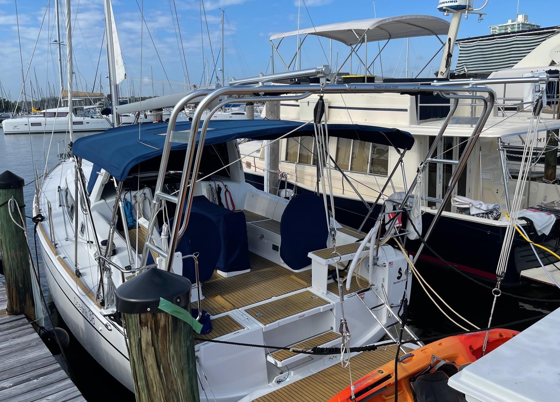 Atlantic Towers Arch installed on a Beneteau sailboat, featuring a navy canopy and deck area at the marina.