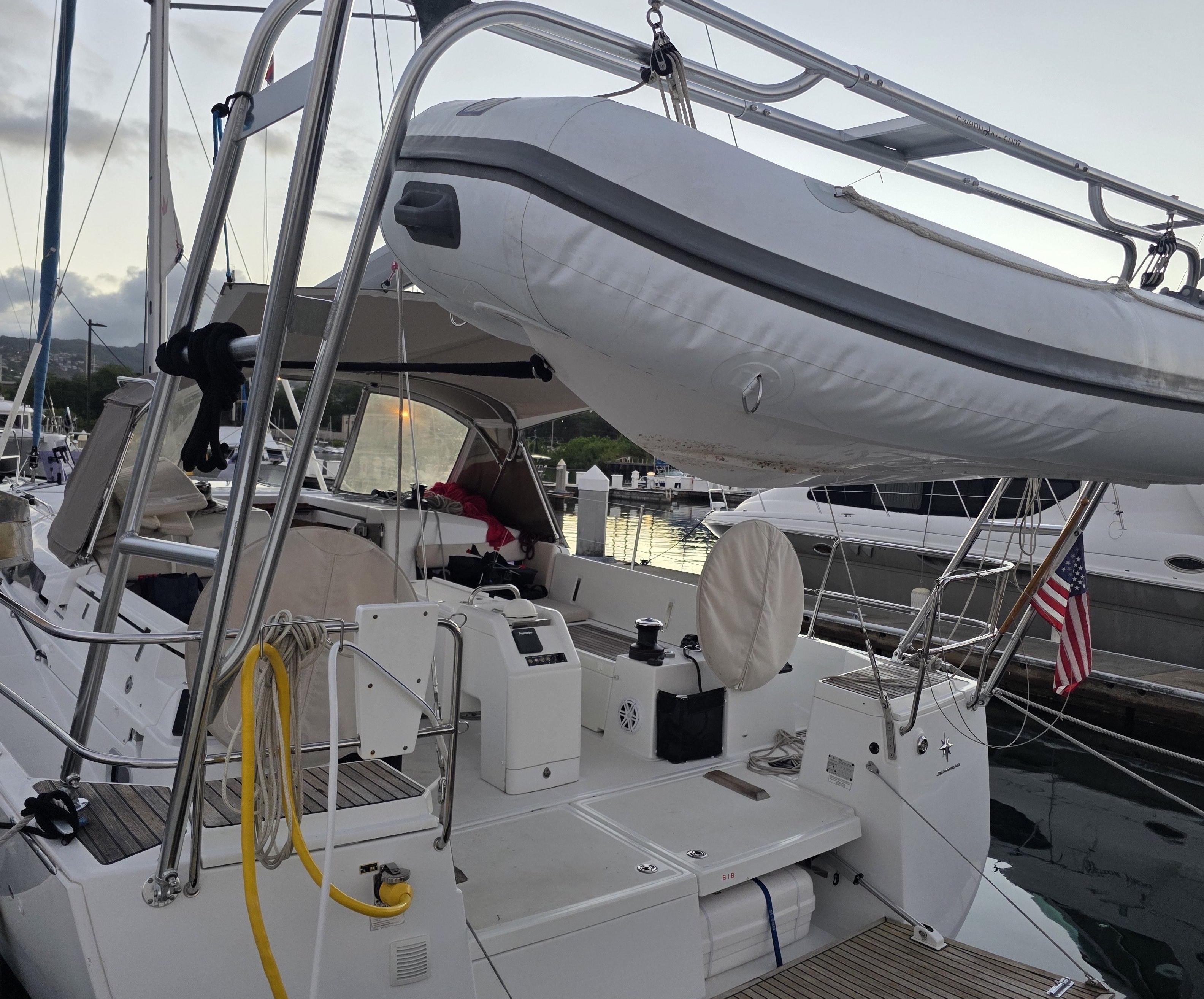 Atlantic Towers Arch made of stainless steel installed on a Jeanneau boat with a white inflatable lifeboat hoisted above the deck.