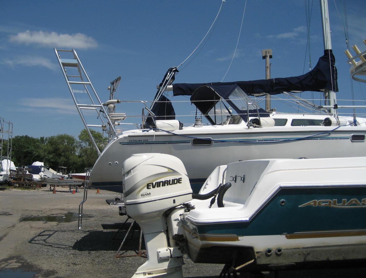 Atlantic Towers Arch installed on a Catalina 320 sailboat at a marina with other boats in the background.