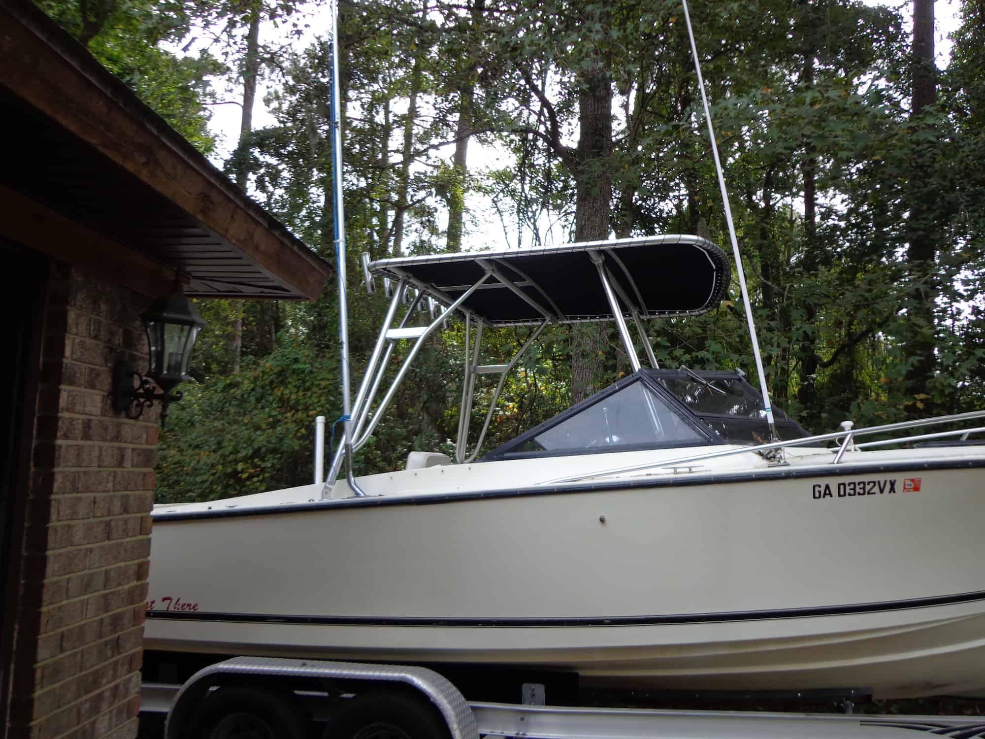 Albemarle boat with installed Atlantic Towers Top aluminum tower and black canvas shade on trailer near wooded area