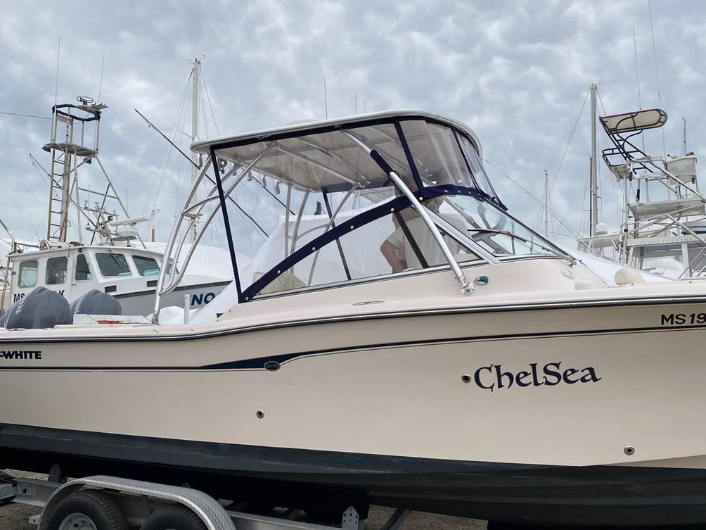 Atlantic Towers Top installed on a Grady White boat named ChelSea, docked with cloudy skies in the background.
