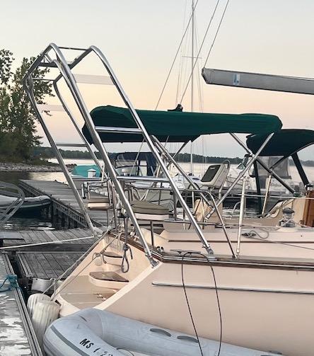 Atlantic Towers Arch mounted on a boat at a marina, with sails and other boats in the background.
