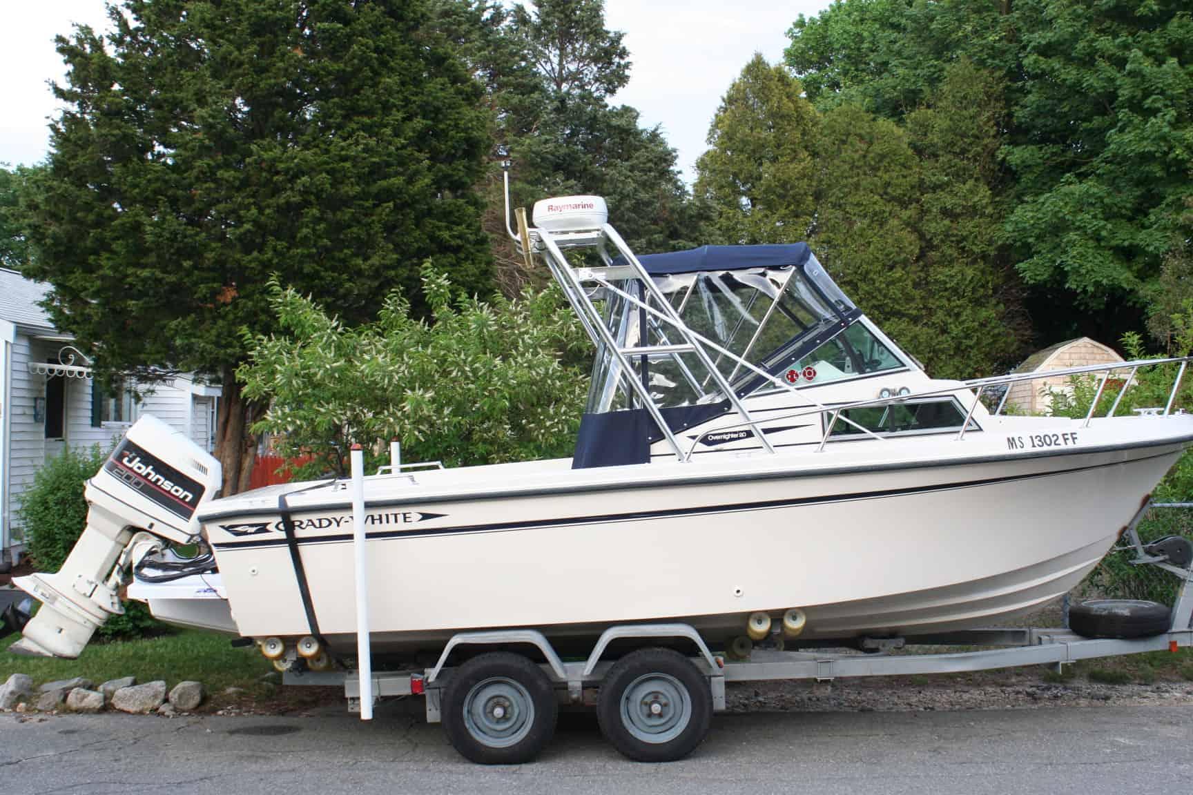 Atlantic Towers arch installed on a Grady White 204C boat, parked on a trailer in a lush outdoor setting.