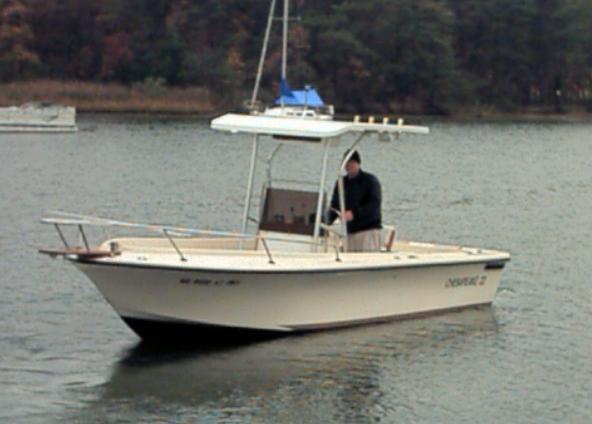 Atlantic Towers Uncategorized installed on a small center console boat with one person onboard on a lake near a wooded shore.