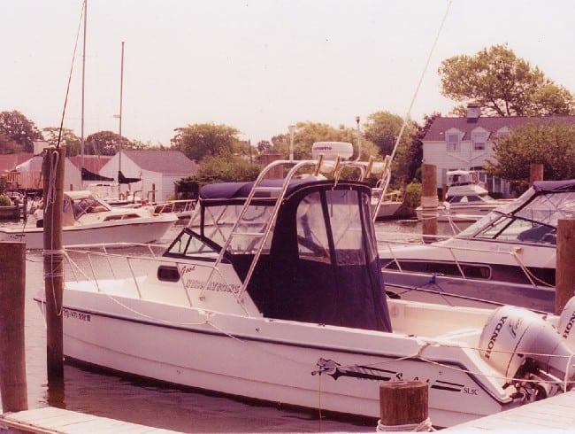 Atlantic Towers Arch installed on a Sea Cat boat docked in a marina with other boats and buildings in the background.