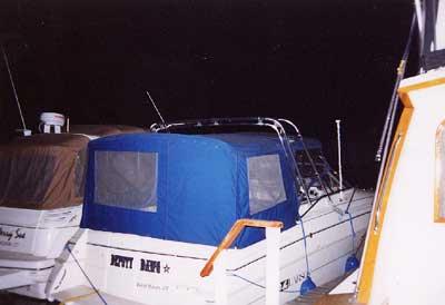 Atlantic Towers Arch installed on a Larson 300/310 Cabrio boat, docked at night with other boats nearby.