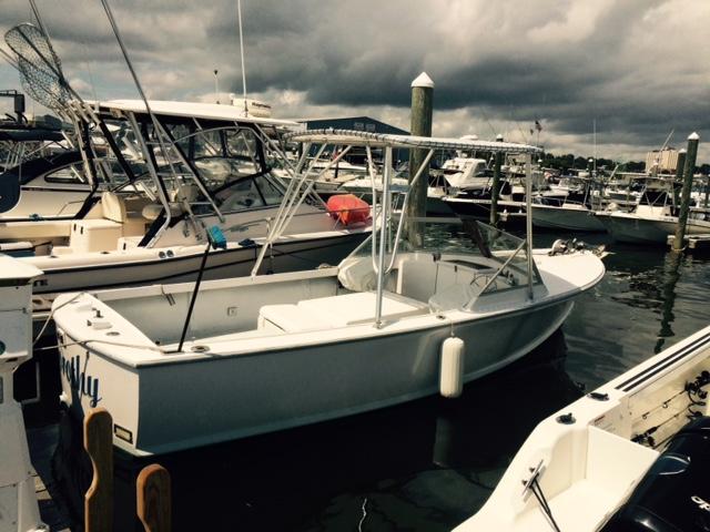 Atlantic Towers Top installed on a boat docked at a marina, surrounded by other boats and mooring posts.