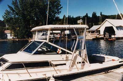 Atlantic Towers Top installed on a Wellcraft 248 Sportsman/Coastal boat docked near a waterfront with buildings and trees in the background.