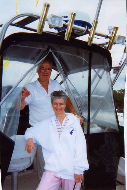 Atlantic Towers arch on a Wellcraft 250 Sportsman boat with two people in front of a transparent enclosure.