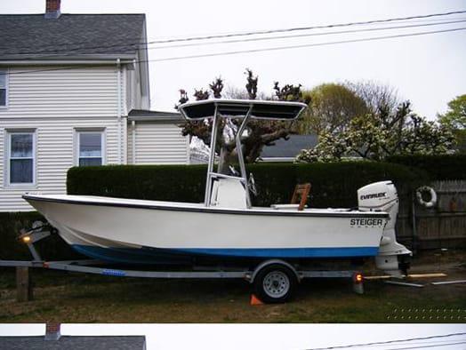 Steiger Craft boat with installed Atlantic Towers T-Top canopy on a trailer in a residential yard.