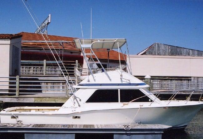 Atlantic Towers Top installed on a Chris Craft Tournament boat docked by a marina with buildings in the background.