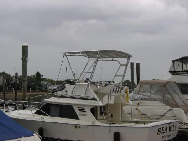 White Blackfin 29 Flybridge boat docked with Atlantic Towers Top installed on the flybridge under cloudy sky