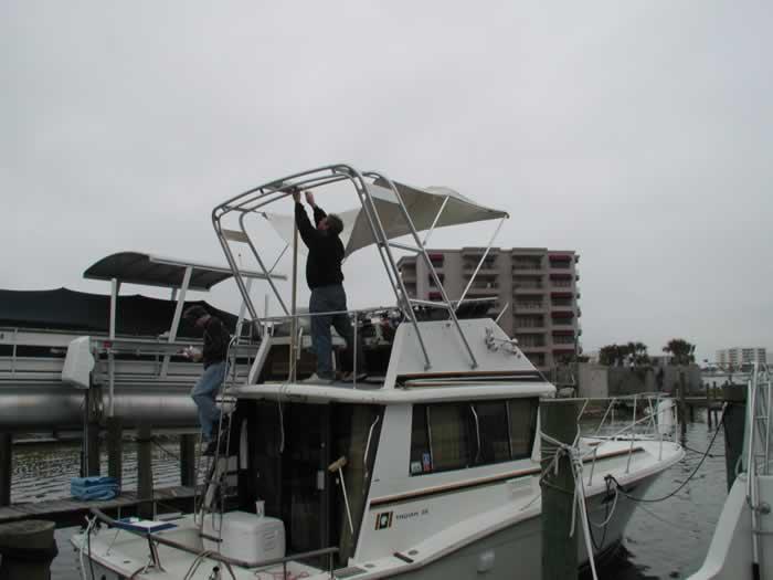 Atlantic Towers Arch installed on a Trojan F32 sedan boat showing its curved aluminum frame above the cockpit.
