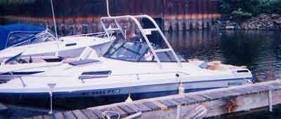 Atlantic Towers Arch installed on an Ebbtide 190 Cuddy boat moored at a dock by the water.