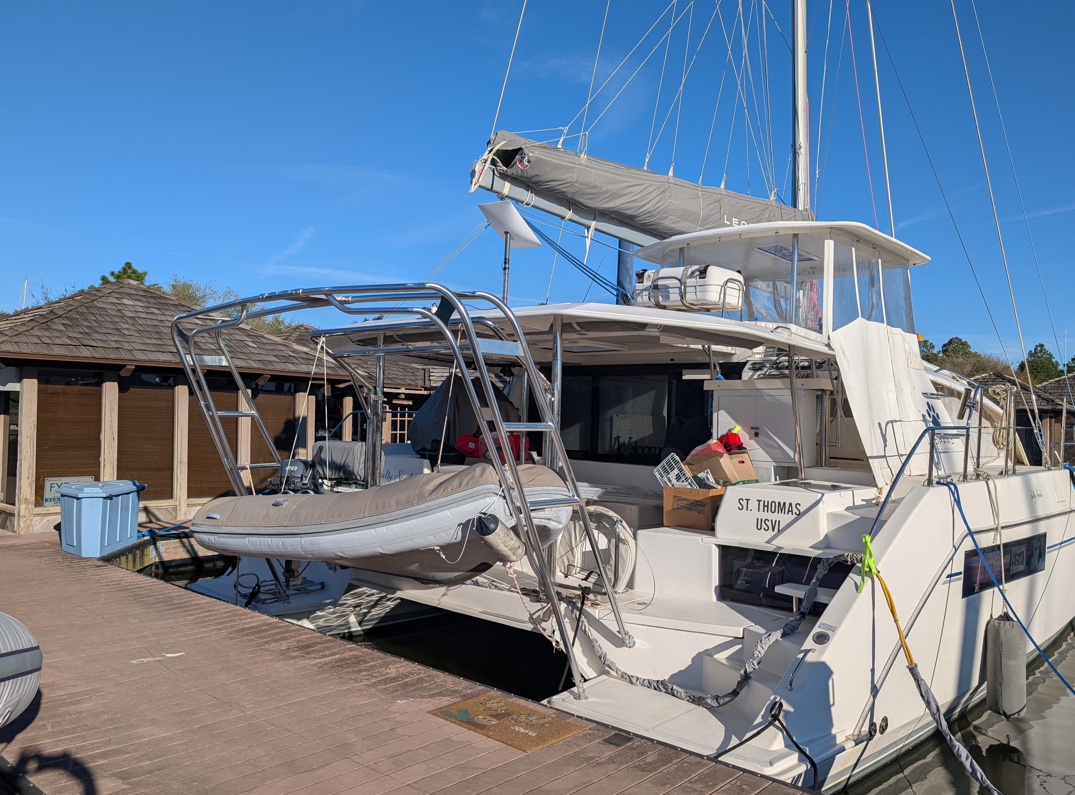 Atlantic Towers Arch installed on a Leopard boat docked at a marina, featuring a partially covered deck and storage.