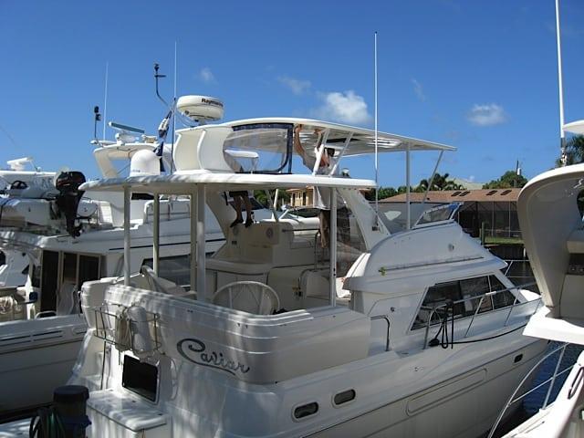 Atlantic Towers Top installed on a Cruisers 2650MY/375MY boat at a marina, with clear skies above.