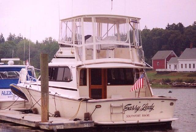 Egg Harbor 37 Convertible boat docked with Atlantic Towers Top enclosure and American flag in Southport, Maine
