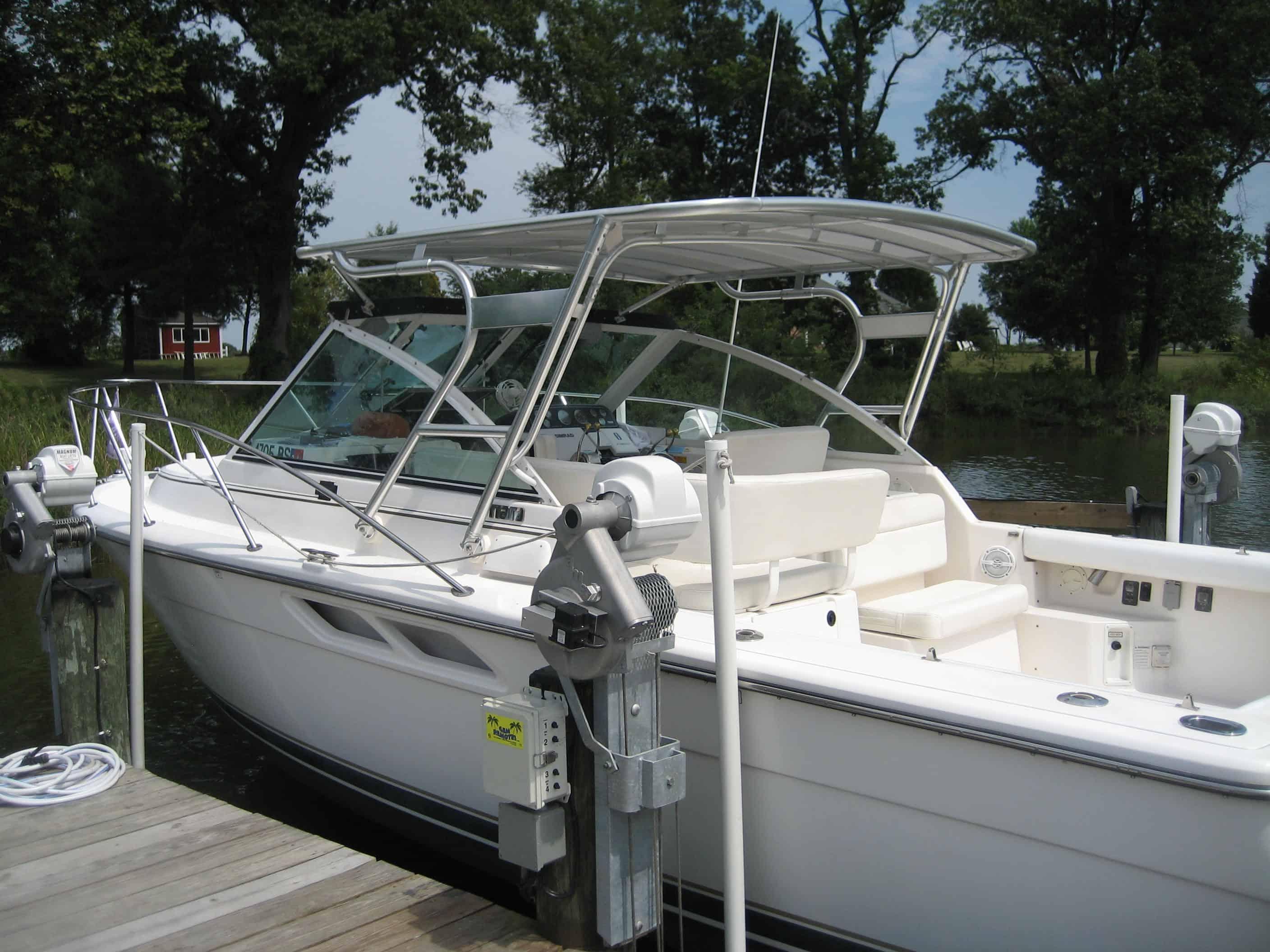 Atlantic Towers Top installed on a white boat docked at a marina, surrounded by trees and water.
