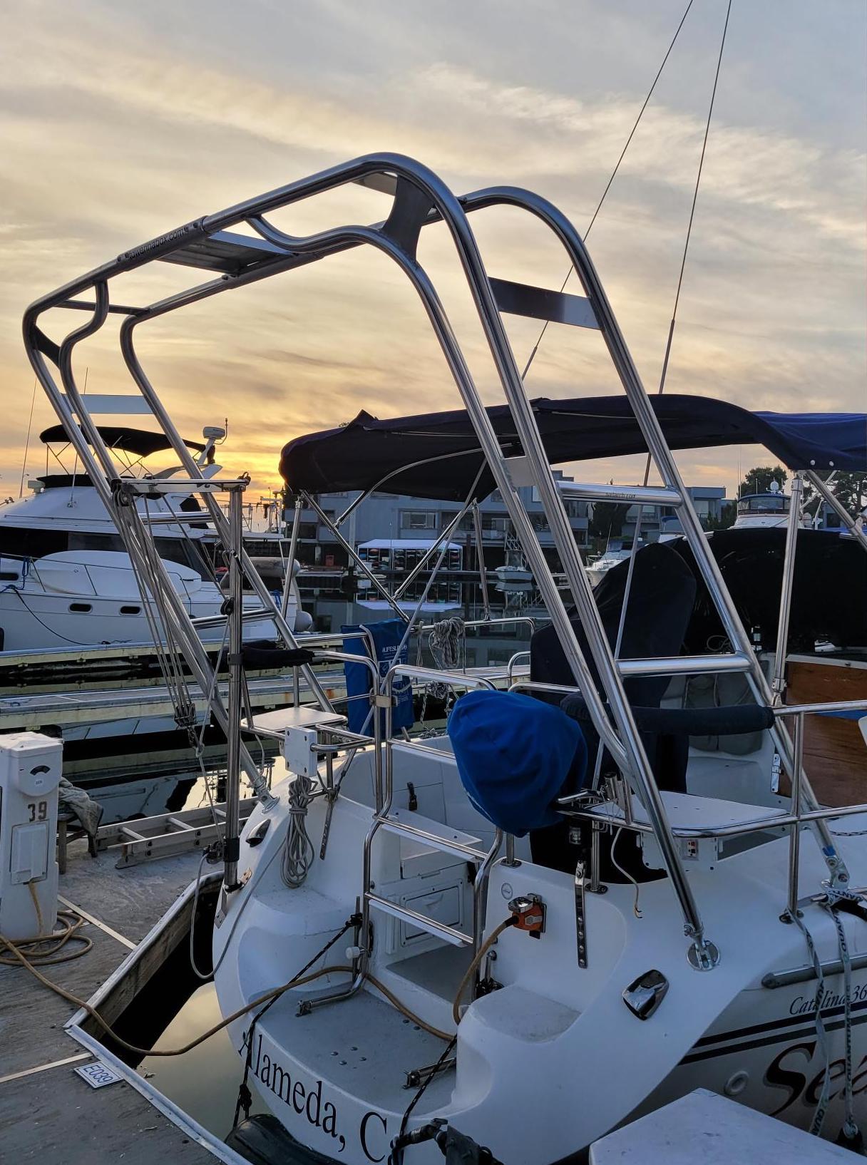 Atlantic Towers Arch installed on a Catalina boat at a marina during sunset, with boats in the background.