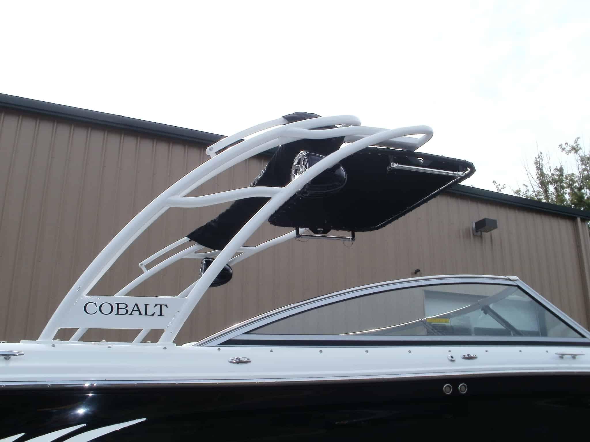 Atlantic Towers arch installed on a Cobalt A25 boat, showcasing its sleek white design against a building backdrop.