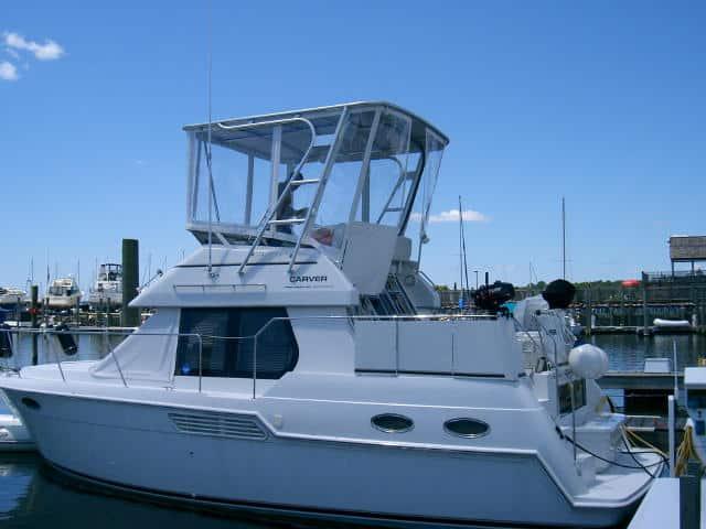 Carver 326 Aft motor yacht docked at marina with installed Atlantic Towers Top on flybridge under clear sky
