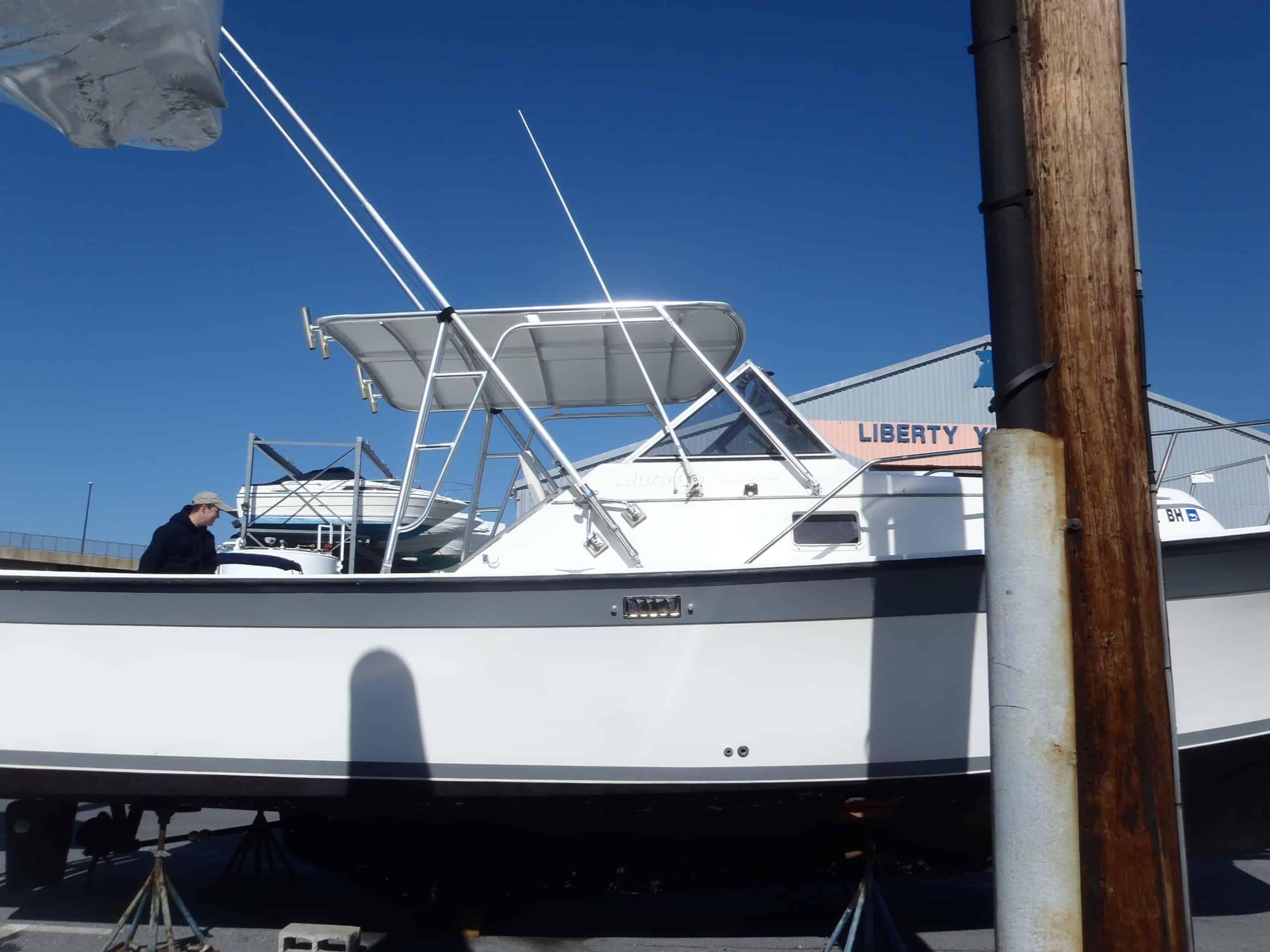 Atlantic Towers Top installed on an Alura 30 boat, displayed on a trailer with a clear blue sky.