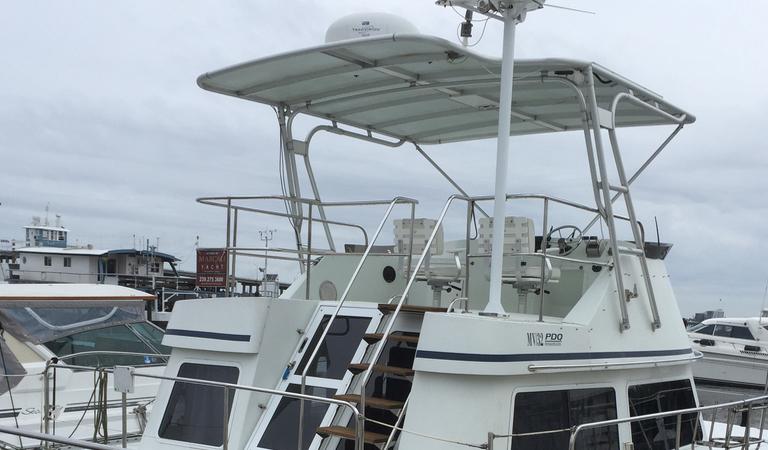 Atlantic Towers Top installed on a PDQ boat, featuring a spacious upper deck and railing for safety.