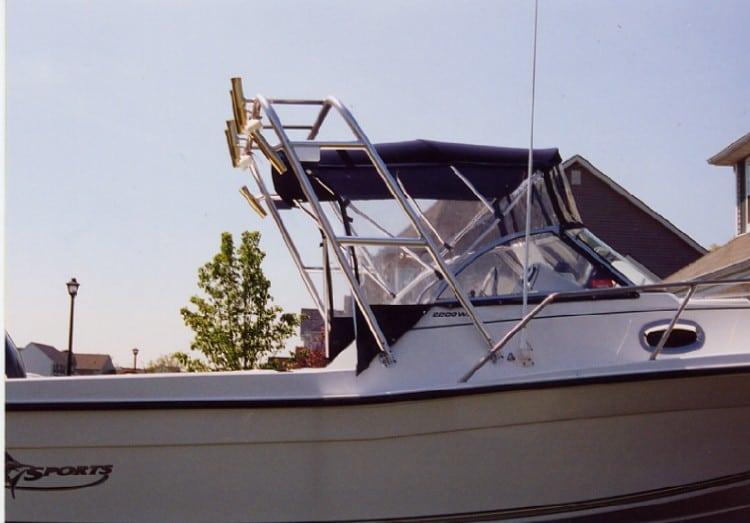 Side view of a Pro Sport 2200 Walkaround boat with an installed Atlantic Towers Arch and mounted fishing rod holders.