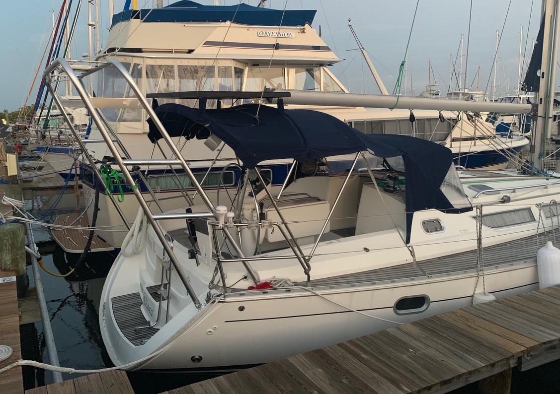 Atlantic Towers Arch installed on a sailboat docked at a marina, showcasing the boat's cockpit and surroundings.