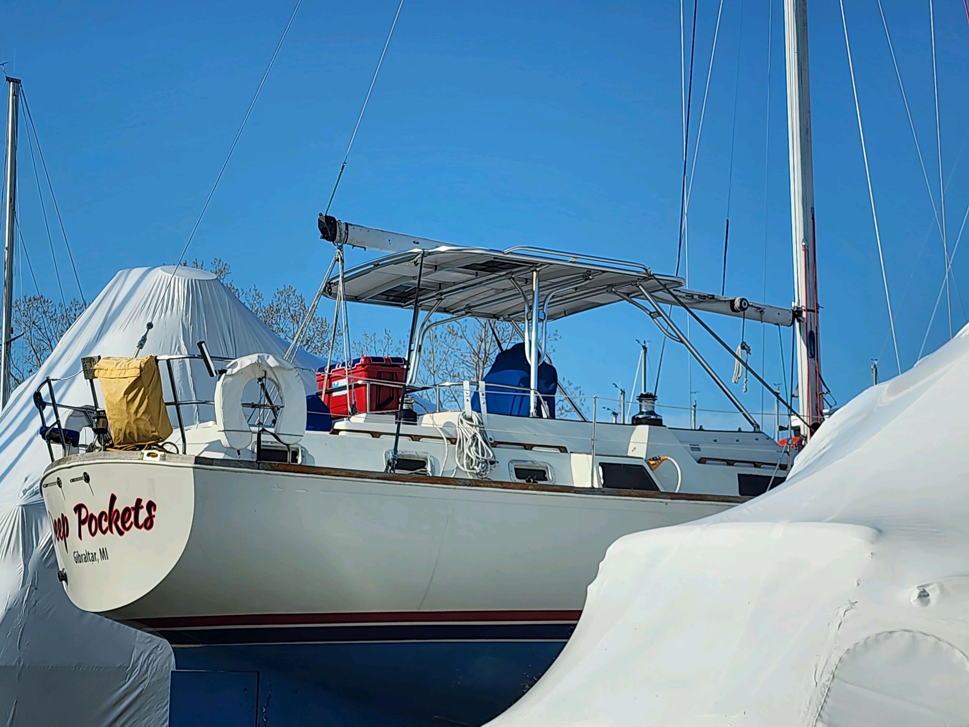 Atlantic Towers Top installed on an O'Day sailboat, stored with a cover in a marina on a clear day.