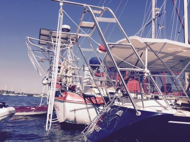Atlantic Towers Arch installed on the stern of a Beneteau sailboat with other boats docked nearby in the water.